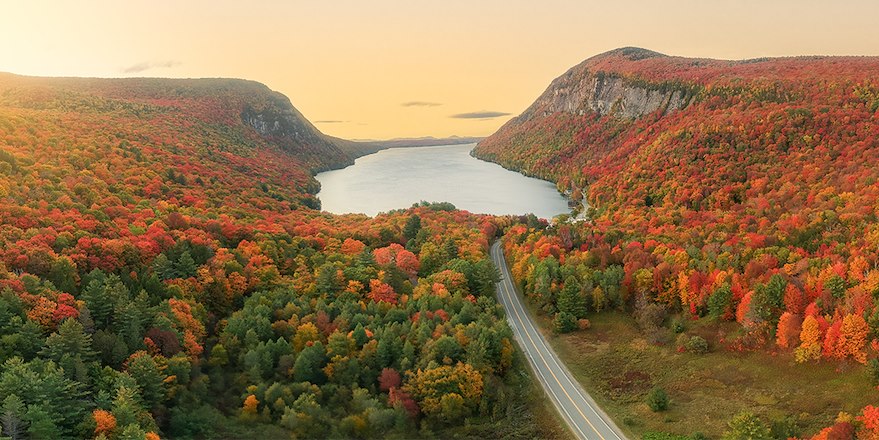 color changing autumn leaves around blue lake